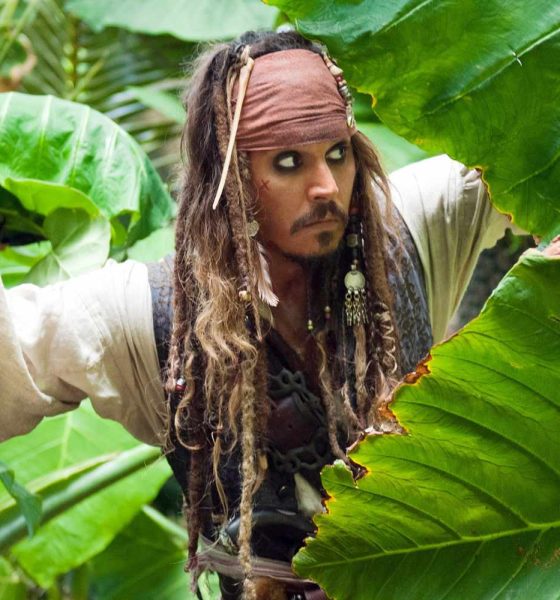 Johnny Depp as Captain Jack Sparrow hiding amongst plants